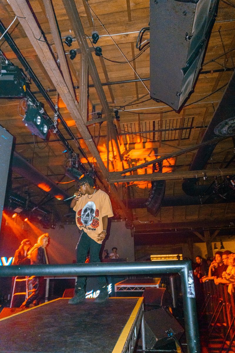 HARLEM at the edge of the Warehouse 1720 stage in a skull graphic tee
