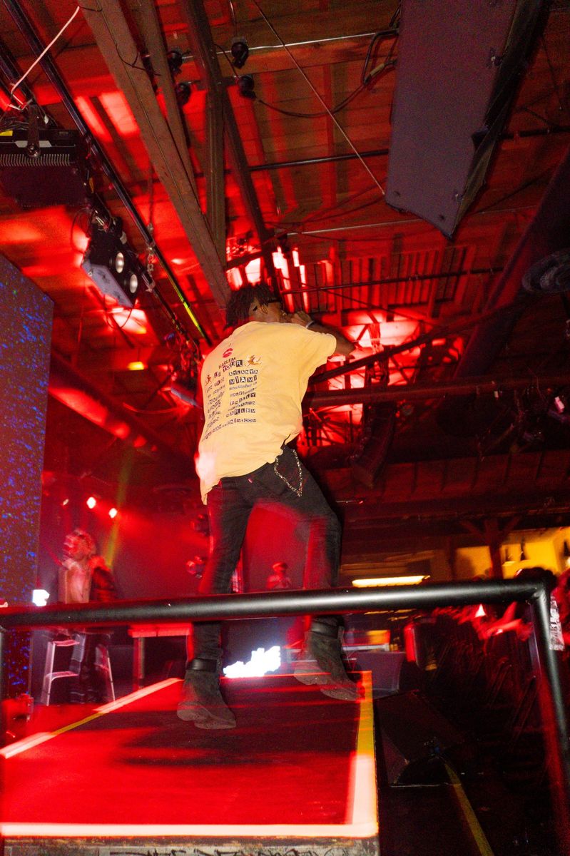 HARLEM on the Warehouse 1720 runway under red light, back print showing
